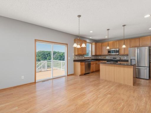 The kitchen opens to the maintenance free deck & features awesome backyard views of the wetlands.
