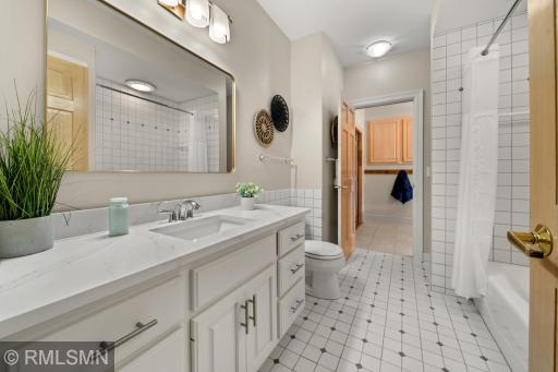 Walk-thru bath area leads out to the pool