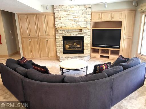 Amusement room stone fplc. and media area with surround speakers