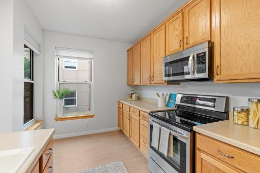 The kitchen is open with a breakfast nook area and includes stainless steel appliances.