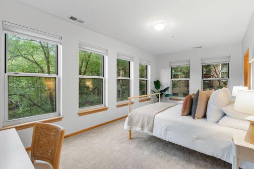 The primary bedroom is extremely spacious and offers beautiful natural light.
