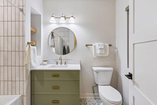 Your main bath is just as nice as the primary with gorgeous, custom tile work and the same stylish look you'll become used to in the rest of your home