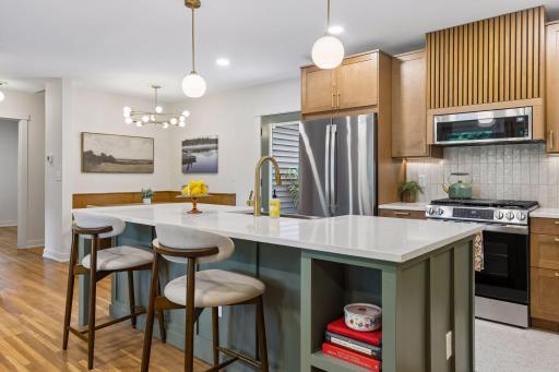 A built-in island book shelf houses all your favorite cookbooks to inspire you in your brand new kitchen - beautiful new cabinets with soft-close drawers & cabinets, new appliances, gorgeous backsplash highlighted by under cabinet lighting...