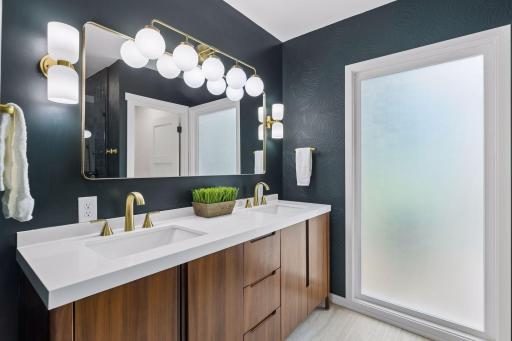 But the real highlight is your private primary bath with huge frosted window bringing in a private natural light and gorgeous dual sink teak vanity