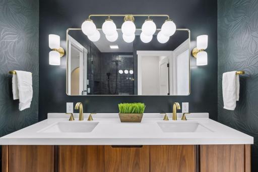 You can't see it in this huge well-lit mirror with separate switch for the dimmable sconce lights but yes, your feet will feel the warm luxury of heated floors