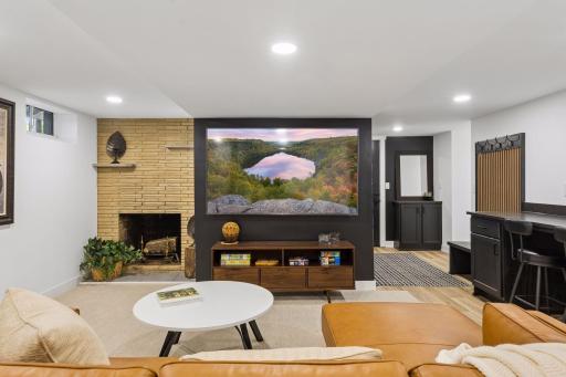 Fresh, new updated lower-level with a cozy original fireplace and new TV wall - that's a 75" perfect for unwinding and enjoying movie night or game day