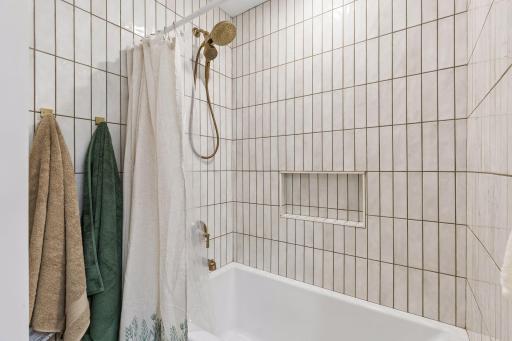The main bath tile just keep going up to the higher-than-normal 8'3" ceiling throughout the main floor adding that little extra to the great spaces