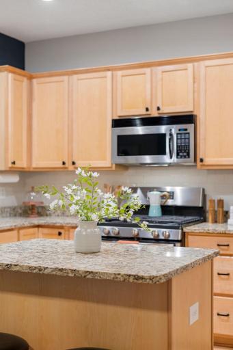 Center island adds additional prep space, storage, and casual seating.