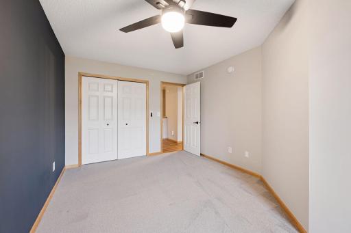 Another view of the second bedroom highlighting the generous closet space and comfortable layout.