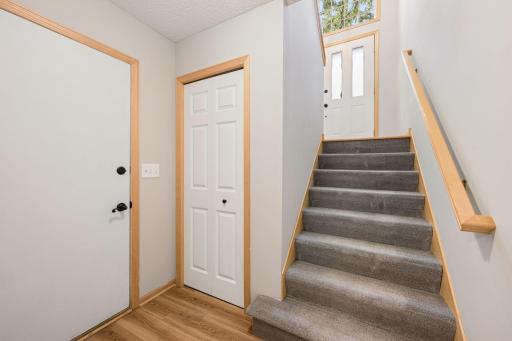 Lower-level entry and stairway offering convenient access between the home's multiple levels.