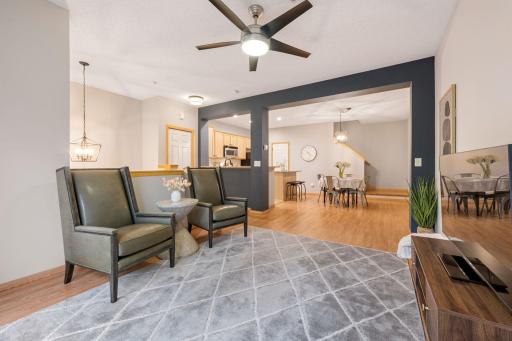 Bright and inviting living room with an open layout connecting seamlessly to the dining area and kitchen.