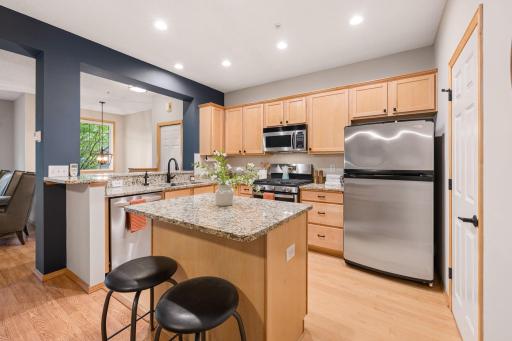 Well-appointed kitchen featuring granite countertops, center island, stainless steel appliances, and ample cabinetry.
