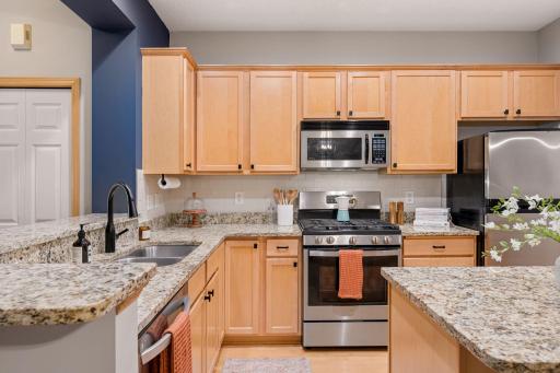 Functional kitchen layout with generous cabinetry, granite countertops, and stainless steel appliances.