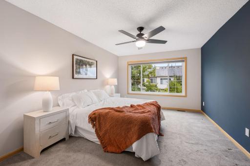Generously sized primary bedroom with plenty of room for a full bedroom set and additional furniture.