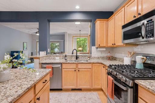 Kitchen offers extensive counter space, recessed lighting, and a bright, open feel.
