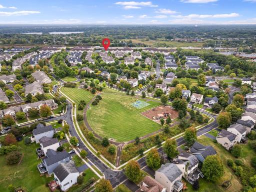 Aerial view highlighting the homeâs close proximity to the neighborhood park, walking paths, playground, and surrounding green space.