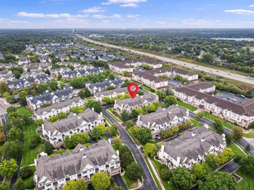 Aerial view highlighting the homeâs convenient location within the community, with easy access to nearby roads, shopping, and surrounding neighborhoods.