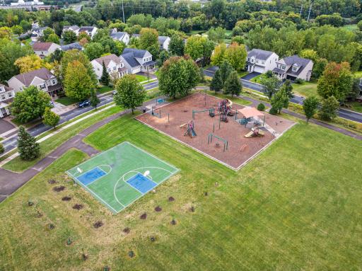 Nearby neighborhood park features a playground, basketball court, walking paths, and expansive green space.