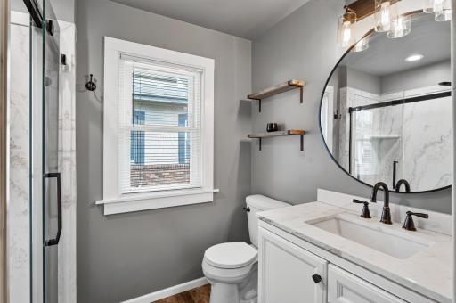 Updated Full Bath with raised vanity adding to the storage space.