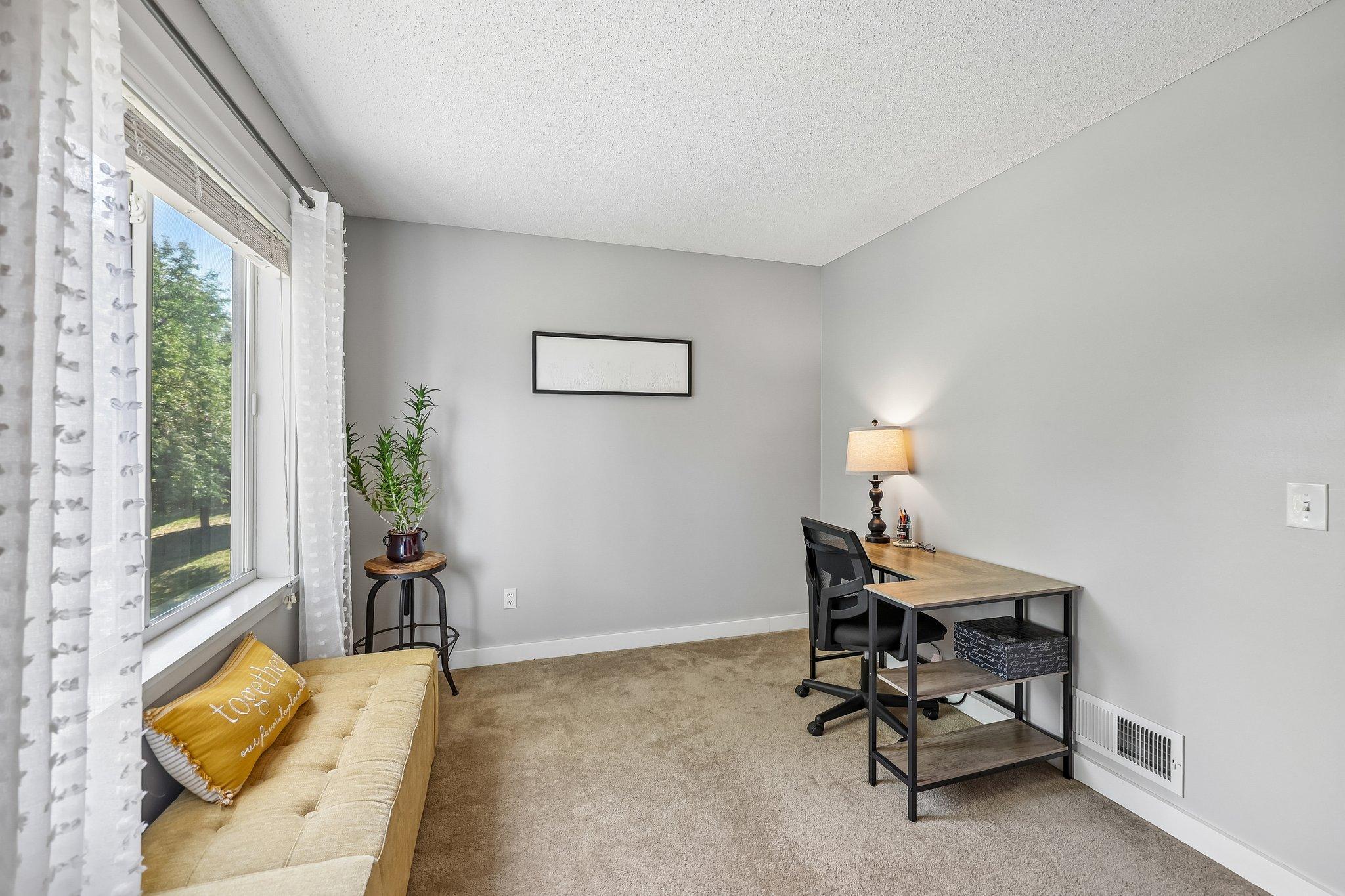 The third bedroom is currently being used as an office space.