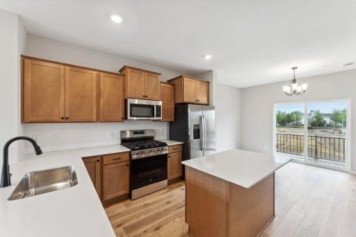 This view highlights the amount of surface space for prep and entertaining needs with the seamless flow into the dining area. Similar home shown, color and options can vary.