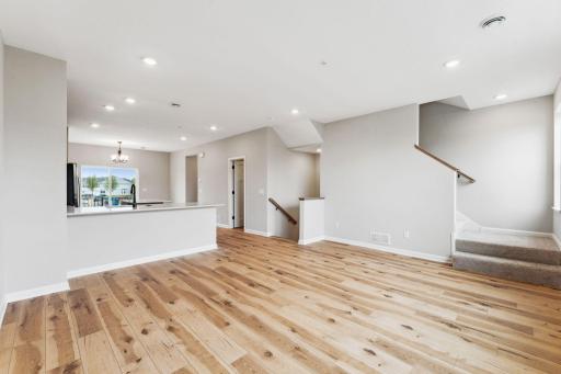 Accented by the warmth of the floors, high ceilings, and large windows, the family room is a great place to gather. Similar home shown. Color and finish can vary.