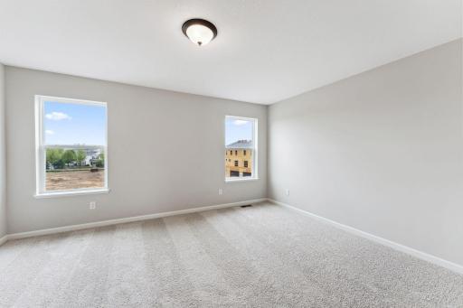 The spacious 17 x 11 owner's bedroom offers the space to create the perfect bedroom oasis. Similar home shown. Color and finish can vary.
