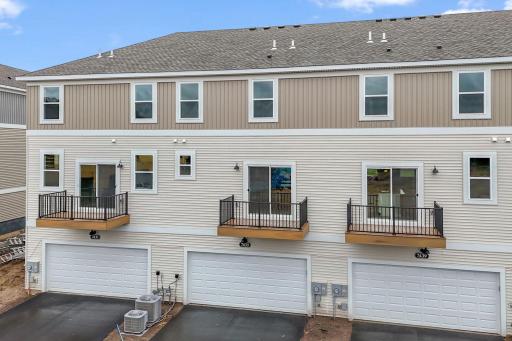 Back of home features a two car garage and maintenance free deck. Similar home shown, color and options can vary.