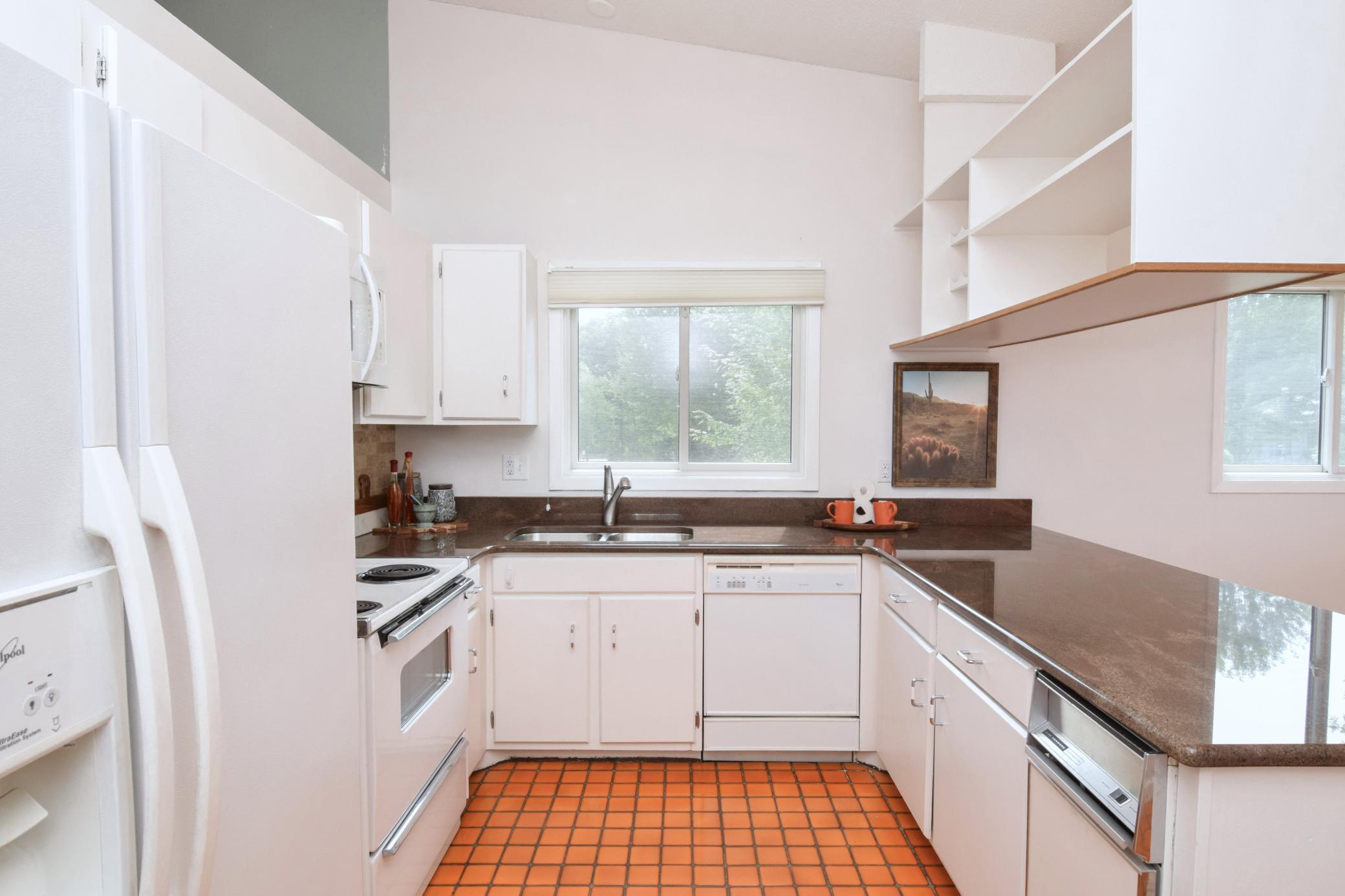 Love the window over the sink, offering a pretty view and bringing in plenty of natural light—
