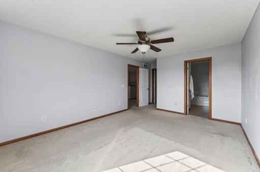 Primary bedroom - entry (left), closet (middle), and bathroom (right).