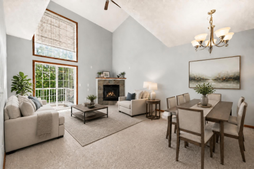 Living room has a gas fireplace and access to the deck. (Virtually staged)