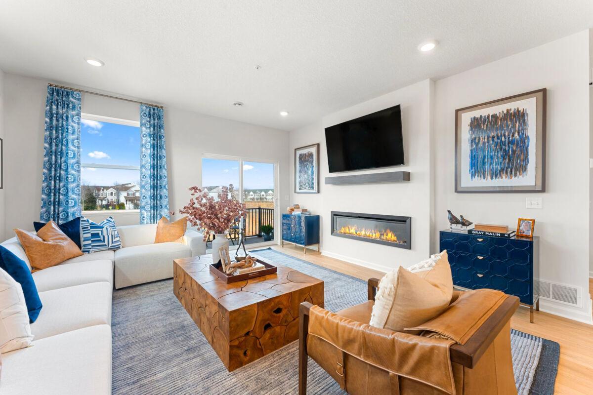 Alternate view of the family room that leads out to the balcony that provides a relaxing outdoor living space. (Photo of model home, color and options can vary.)