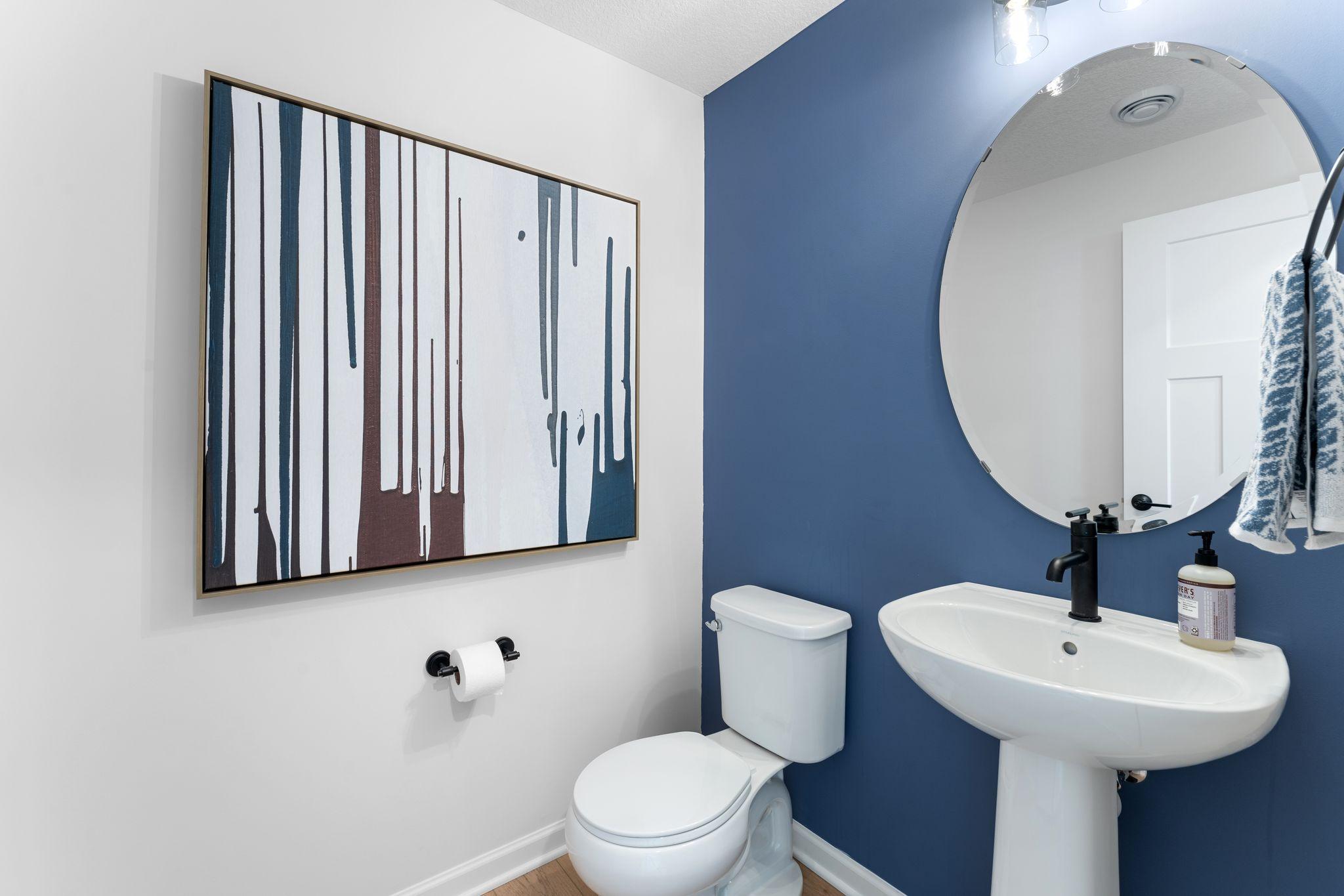 The main level powder bath is in the ideal location and perfect for servicing the main level. (Photo of model home, color and options can vary.)