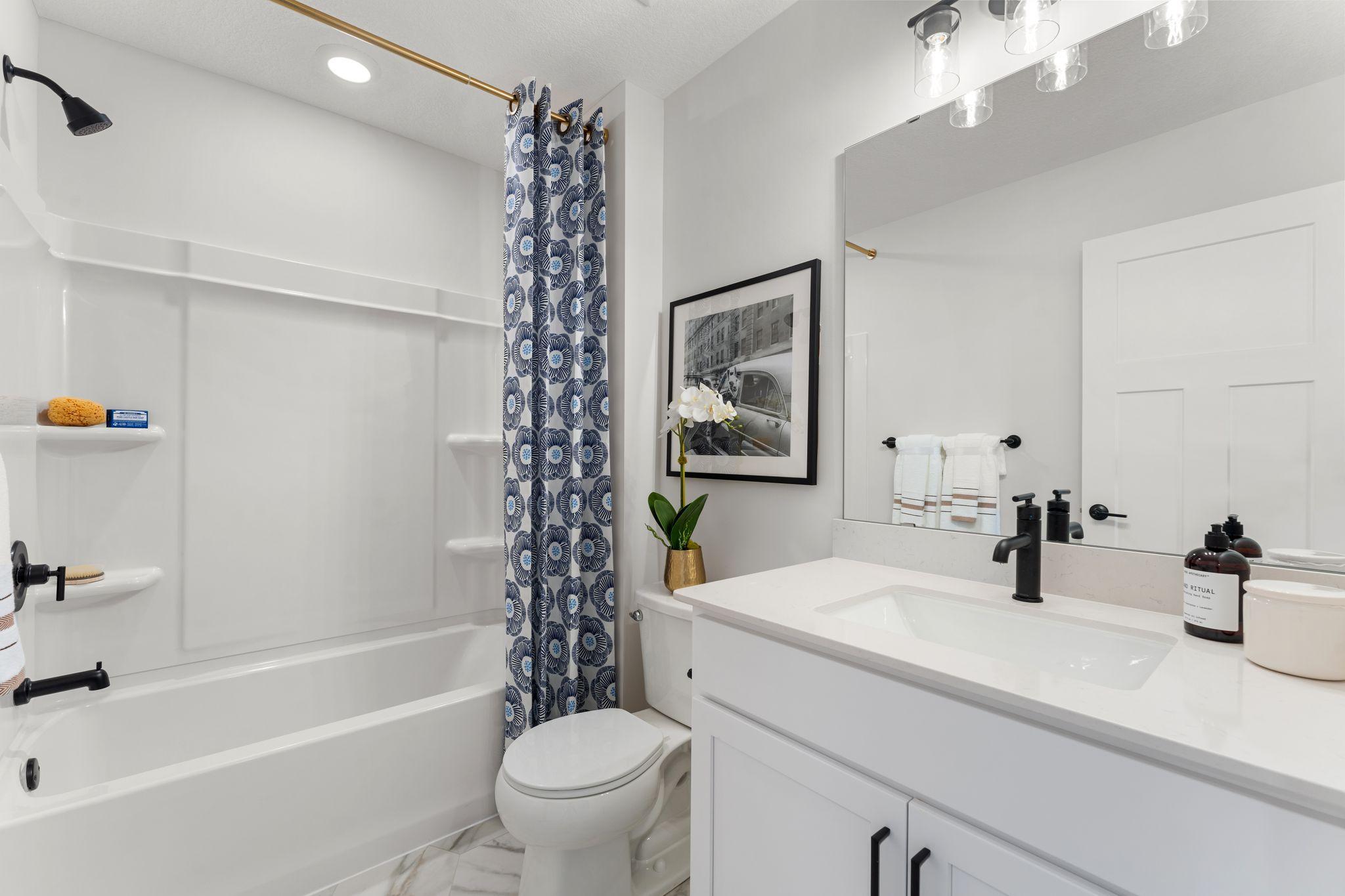 The upper level main bath is convenient and spacious! It is perfect for the two other upper level bedrooms to utilize. (Photo of model home, color and options can vary.)