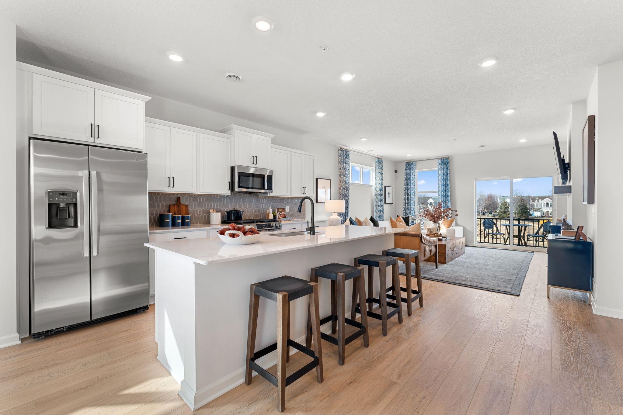 The large multi purpose island adds additional storage, surface space, and seating making entertaining a breeze. Similar home shown, Color and options can vary.