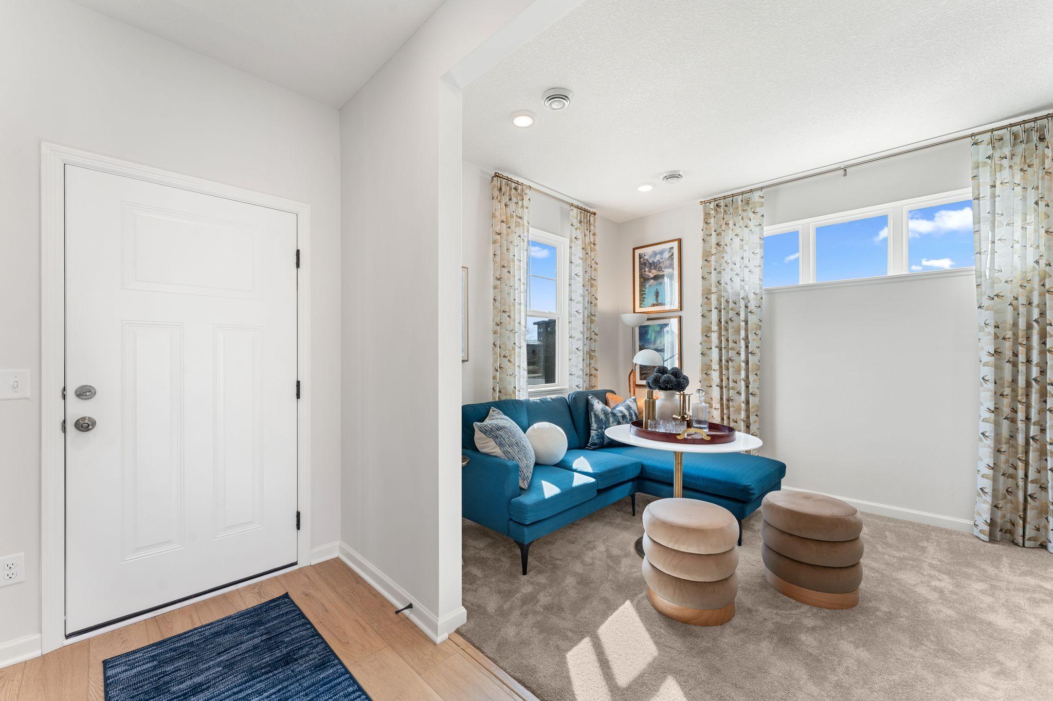A bright and welcoming foyer featuring luxury vinyl plank flooring provide clean sightlines that immediately showcase the home's open and functional layout. (Photo of model home, color and options can vary.)