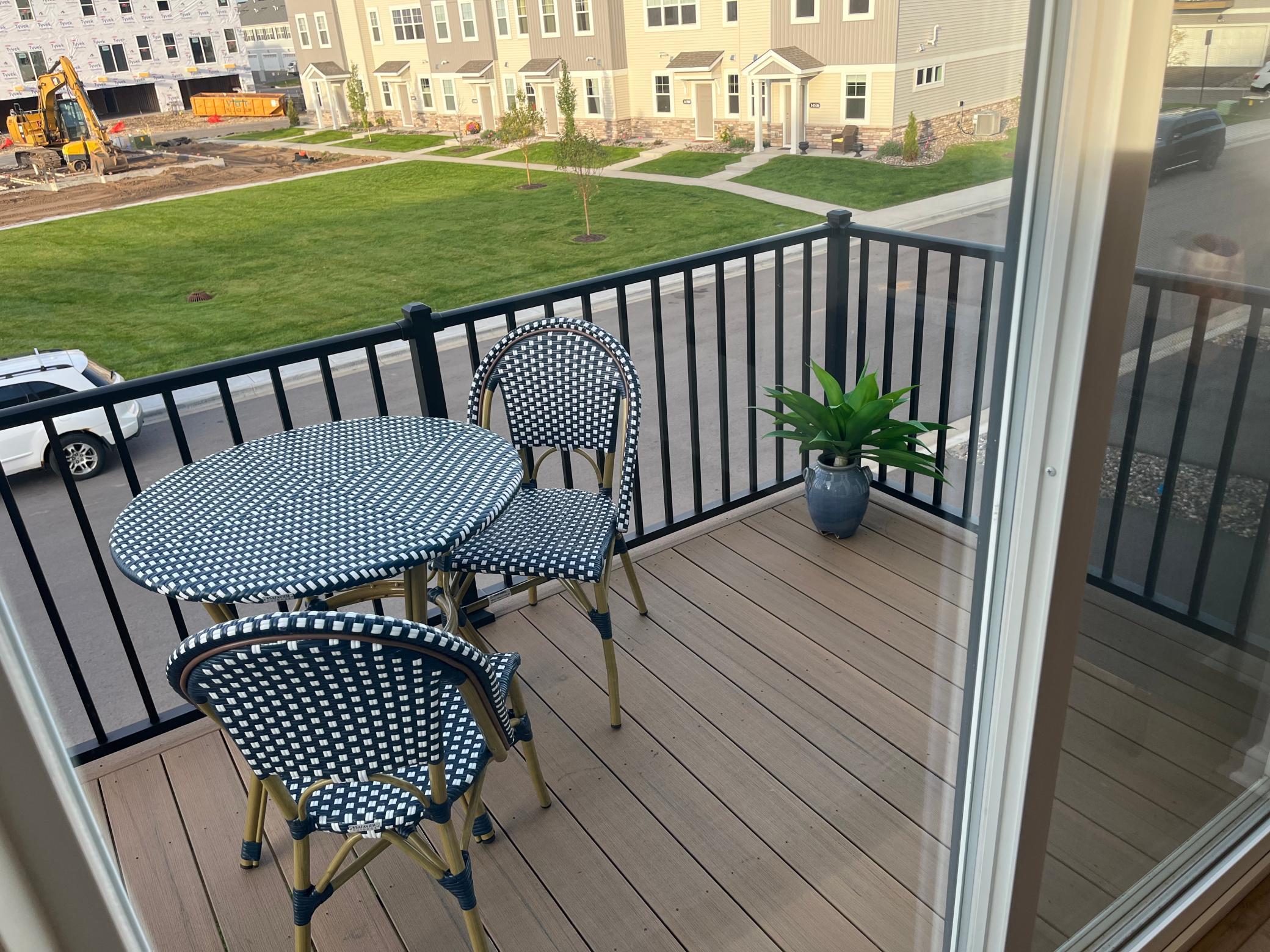 Enjoy outdoor living with a morning coffee or an evening meal on the spacious balcony. (Photo of model home, color and options can vary.)