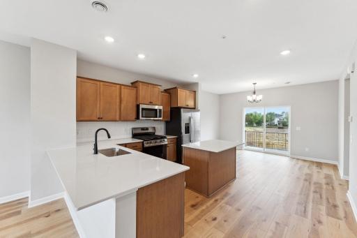 This L-shaped kitchen provides an optimal flow with a breakfast bar for added seating. Similar home shown, color and options can vary.