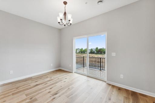 Dining room with easy access to the maintenance free deck. Similar home shown, color and options can vary.