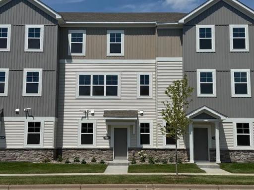 Modern design highlighted by stone accents & clean architectural lines. A charming front patio offers the perfect spot to relax, while the expansive windows fill the home with natural light. Similar home shown, color can vary.