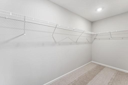 Owner's walk-in closet. Similar home shown. Color and finish can vary.