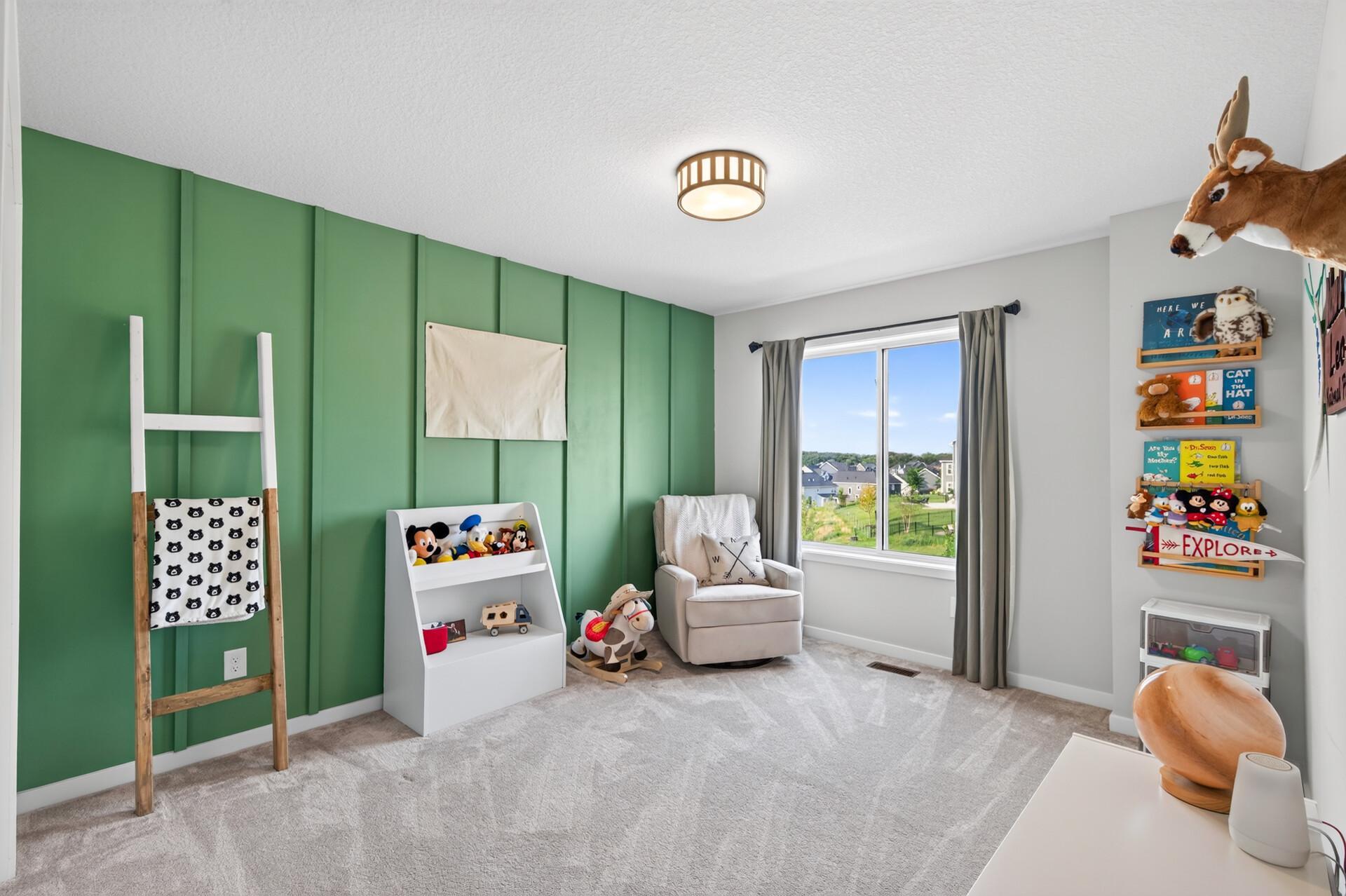 Third upper level bedroom has a darling decorative board and batten wall