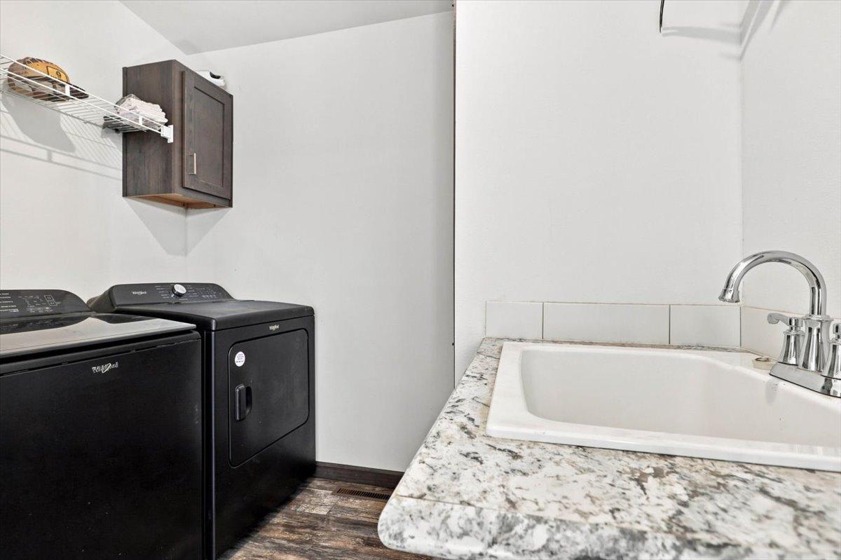 Spacious laundry with door leading to side yard