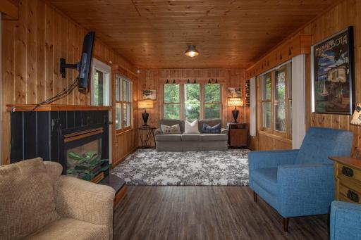 Knotty pine walls and cozy cabin vibes with a gas fireplace