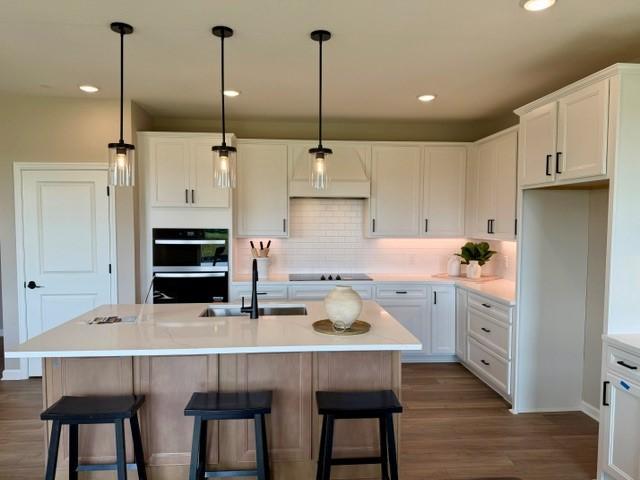 Built-In Kitchen Appliances & Decorative Island with Staging - 4633 Island Park Drive, Woodbury, MN 55129