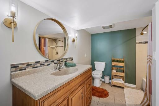 A Beautifully Appointed Walk-Through Bathroom Offers Convenience And Easy Access For Guests And Lower-Level Living Spaces