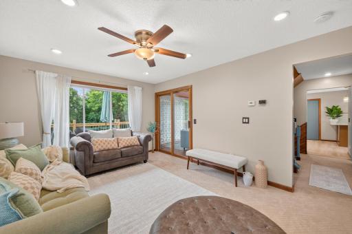 You can access the sunroom and deck from the living room.
