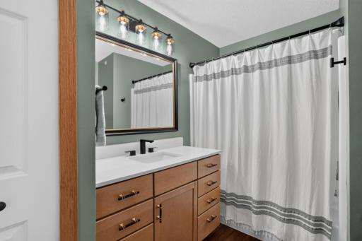 Updated full bath features a new vanity, mirror and light fixture completed in 2025. Updated LVP flooring and a comfort-height toilet.