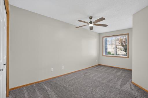 Second bedroom provides flexible space with updated carpet and fresh paint.