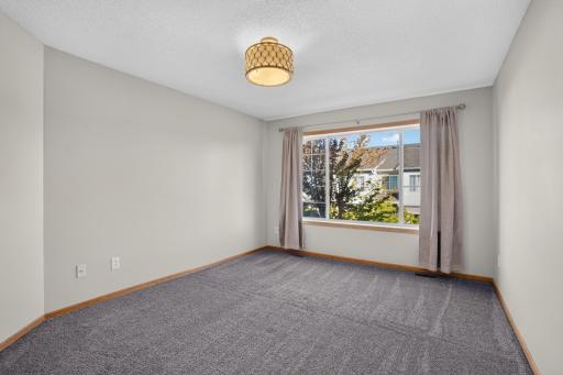 Primary bedroom offers generous space for a variety of furniture arrangements.